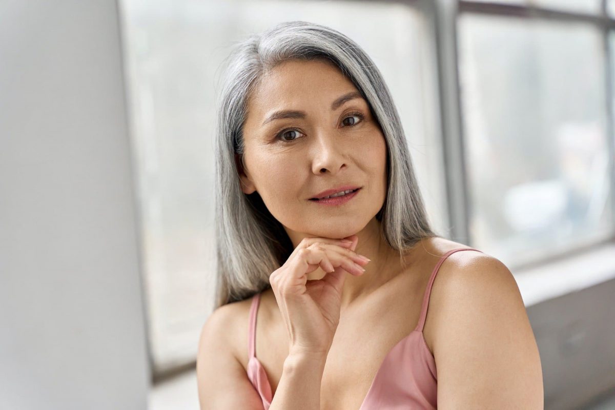 Senior happy middle aged mature asian woman headshot portrait. Skin care advertising.