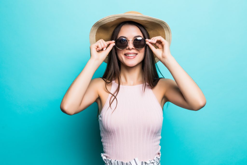 Picture of a woman in sunglasses and hat ready for summer.
